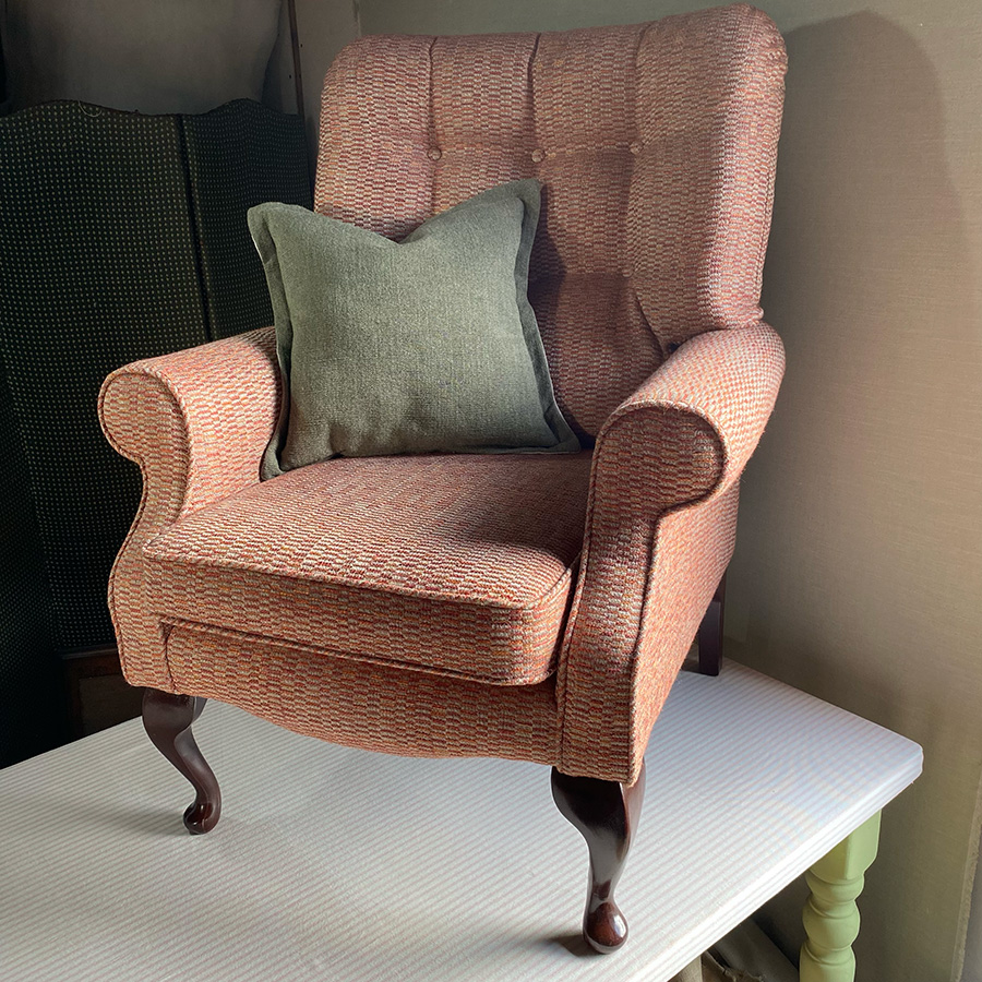 Armchair with fixed rear cushion upholstered in a Linwood fabric